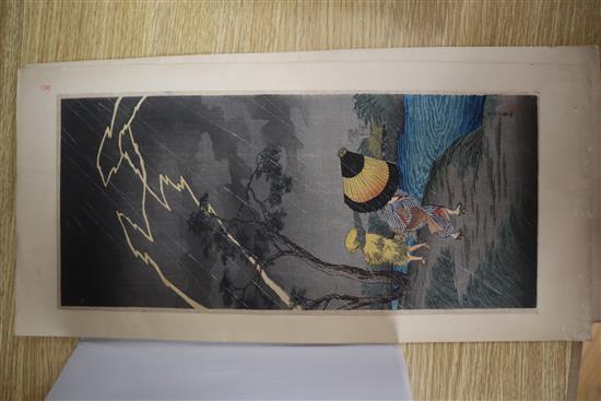 Japanese School, pair of woodblock prints, Travellers in stormy weather, 38 x 17cm, unframed